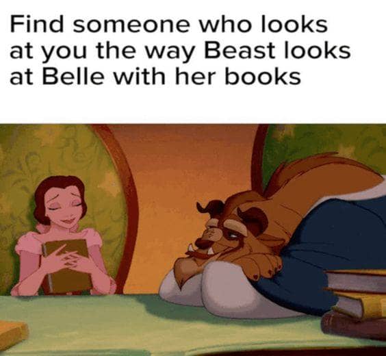 Beast looks at Belle with her books